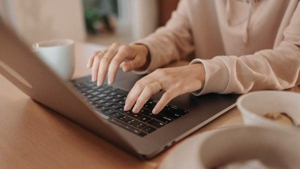 Woman typing on a laptop at a desk