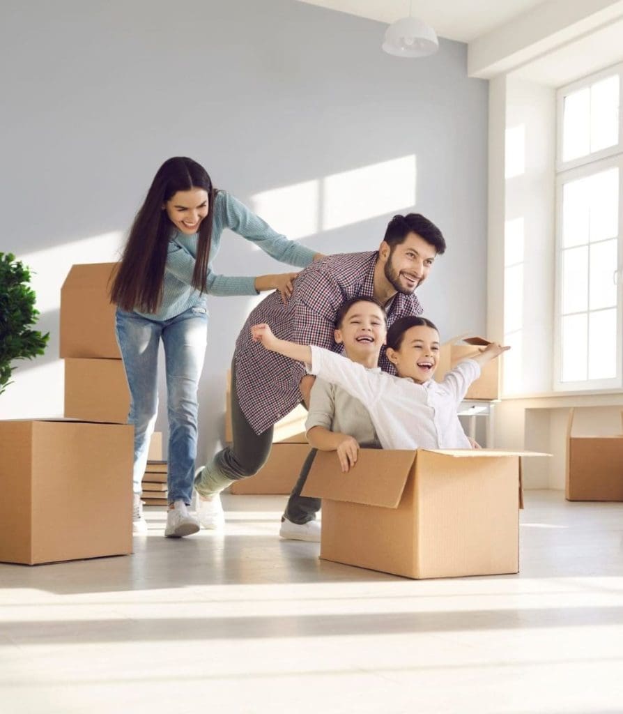 Family playing in their new home just after moving in